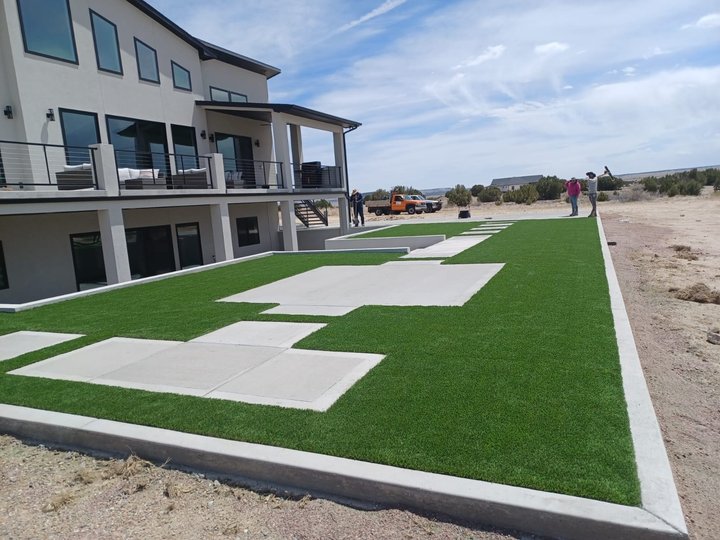 Artificial turf lawn with a concrete paver ribbon at a modern Colorado home