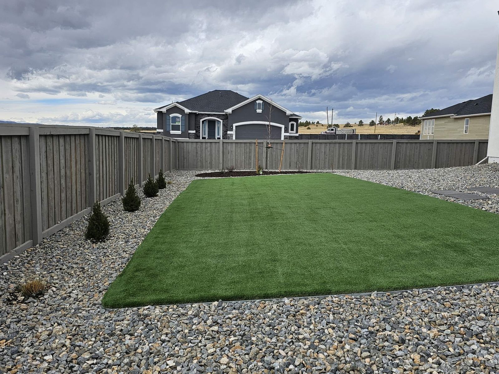 Freshly installed artificial turf lawn in a Colorado Springs backyard