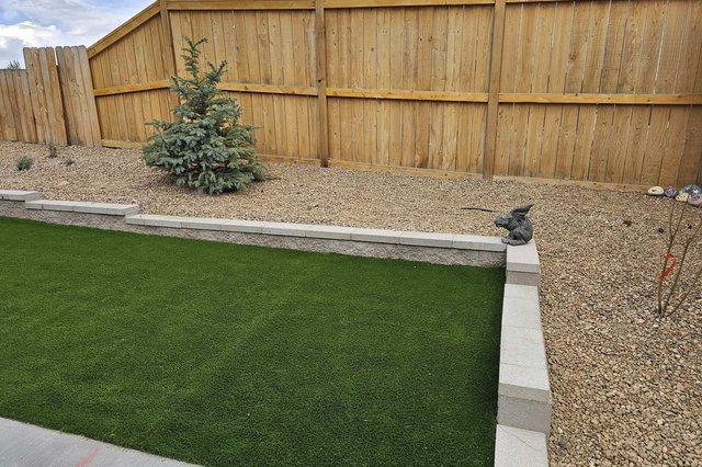Block retaining wall next to an artificial turf lawn in Colorado Springs