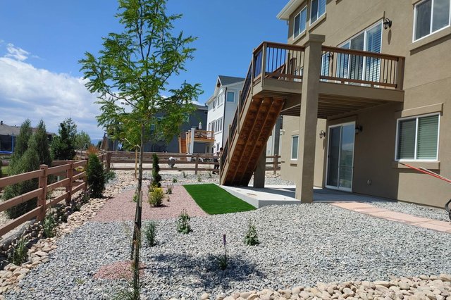 New-build front yard with fresh rock installation and a turf accent in Colorado Springs