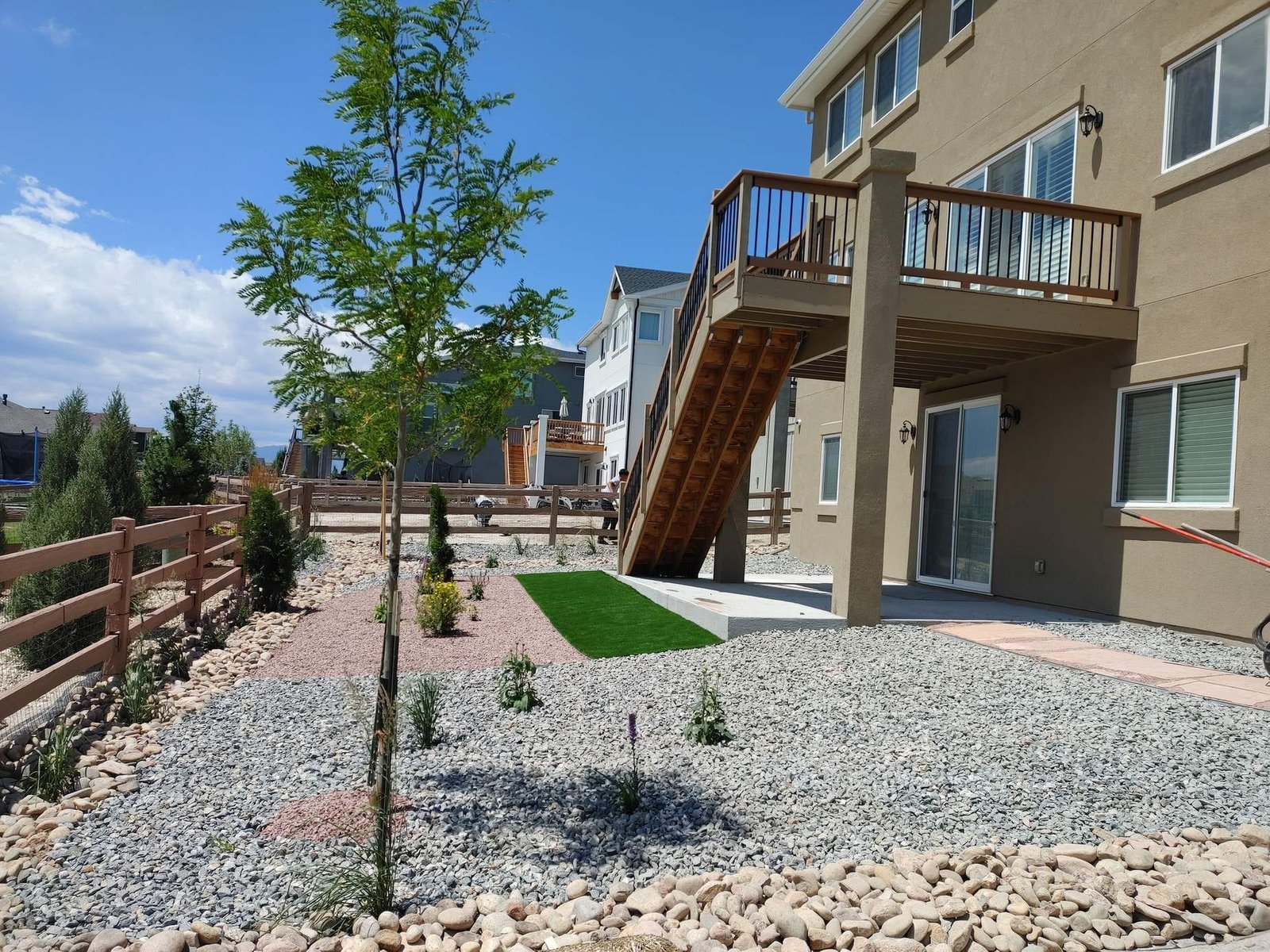 New-build front yard with fresh rock installation and a turf accent, the low-water look Castle Rock HOAs approve
