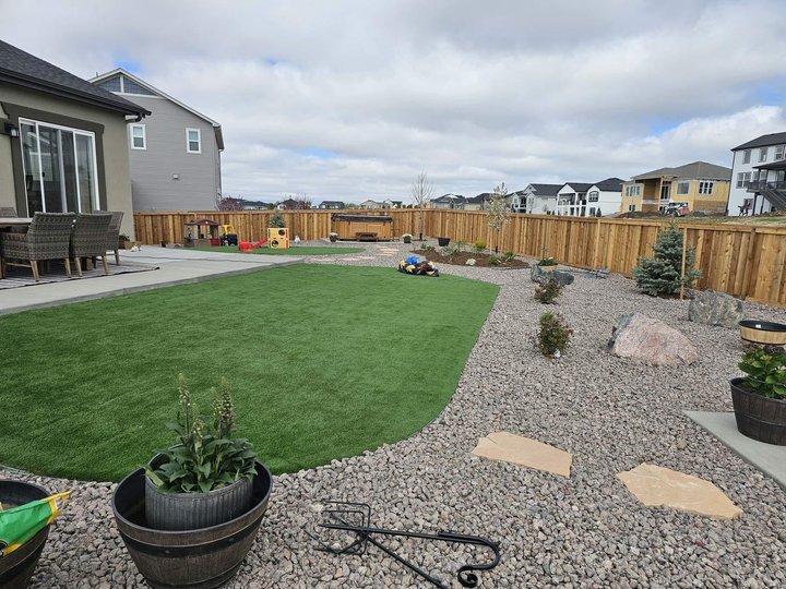 Xeriscape yard with a flagstone path, decorative rock, and a turf accent, low water and low upkeep